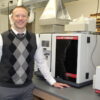 Dr. Doug Swartz standing in chemistry lab with new equipment